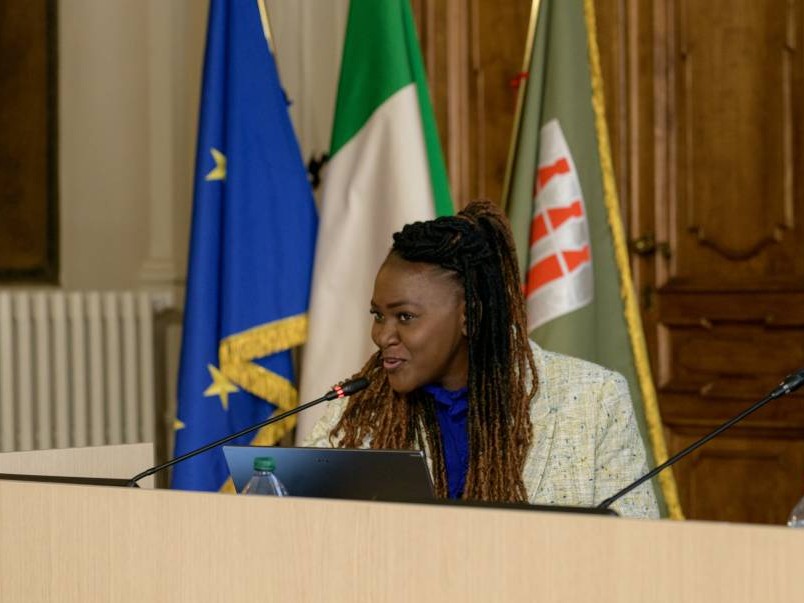 Female presenter hosting a panel discussion